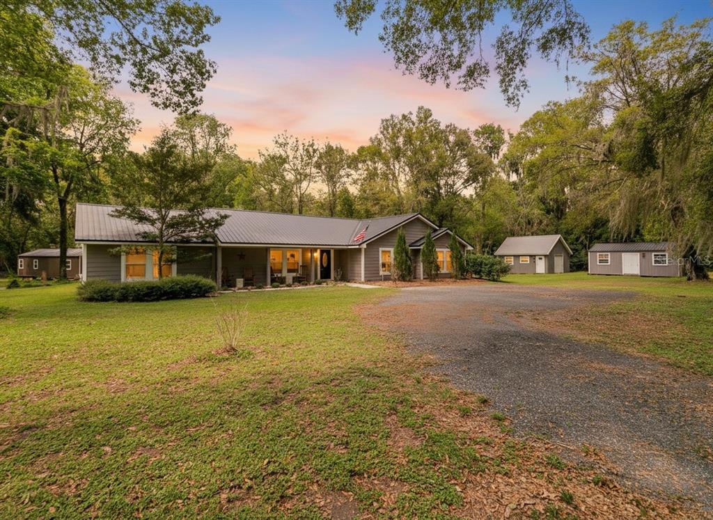 a front view of a house with a garden