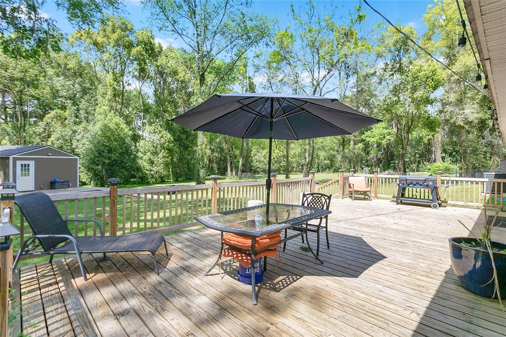 1801 West Highway 329 Citra, FL 32113 - Photo 17 of 34 a view of a chairs and tables in the back yard