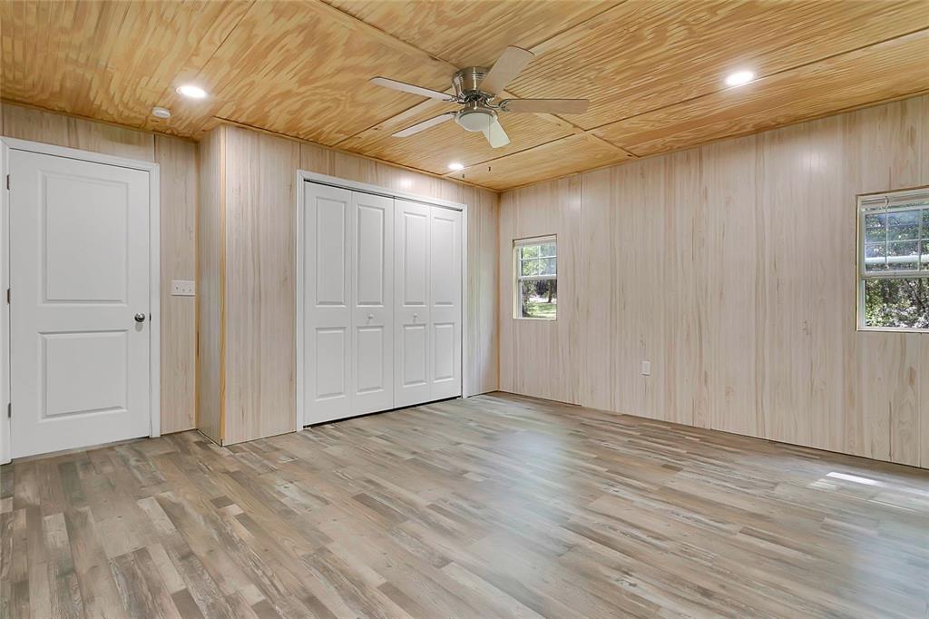 1801 West Highway 329 Citra, FL 32113 - Photo 22 of 34 wooden floor in an empty room with a ceiling fan