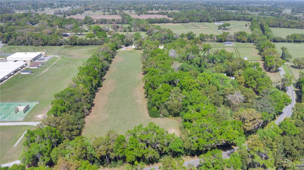 1801 West Highway 329 Citra, FL 32113 - Photo 30 of 34 an aerial view of a house with a yard and lake view