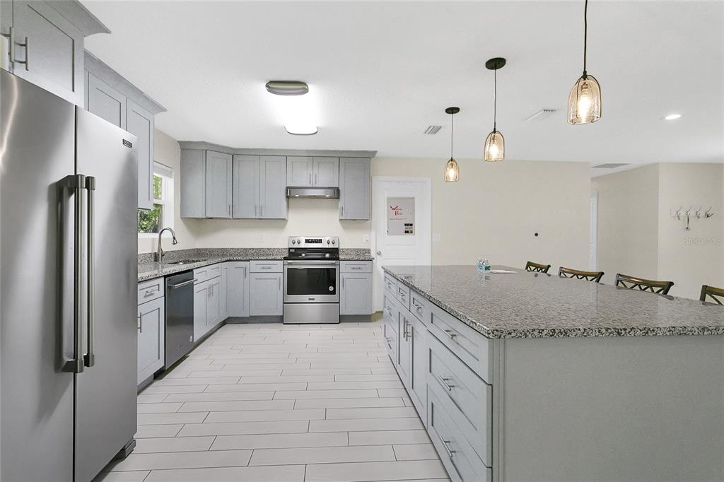 1801 West Highway 329 Citra, FL 32113 - Photo 3 of 34 a kitchen with a sink stove and refrigerator