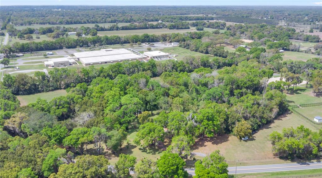 1801 West Highway 329 Citra, FL 32113 - Photo 32 of 34 an aerial view of a houses with a yard and lake