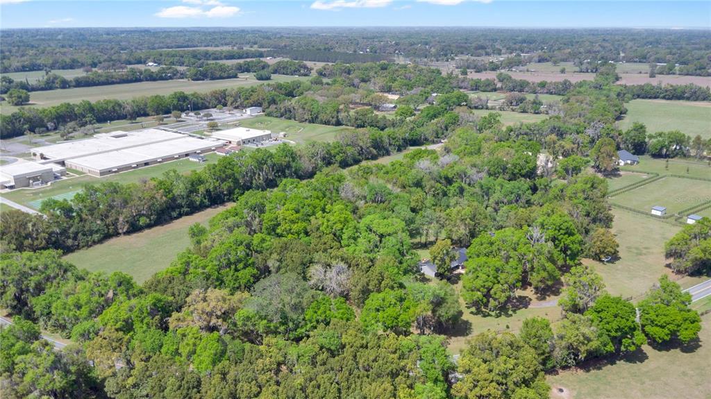 1801 West Highway 329 Citra, FL 32113 - Photo 33 of 34 an aerial view of a houses with a yard and lake view