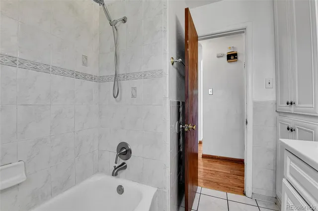 a bathroom with a tub and shower