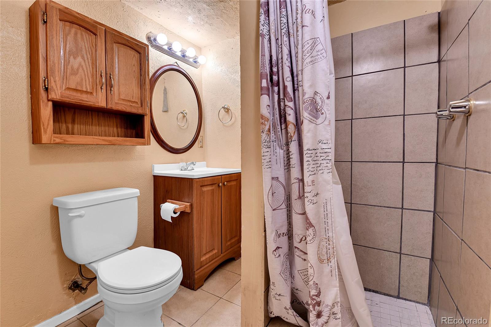 3591 Pontiac Street Denver, CO 80207 - Photo 18 of 26 a bathroom with a toilet and a sink
