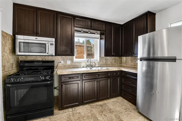 a kitchen with a refrigerator stove and microwave