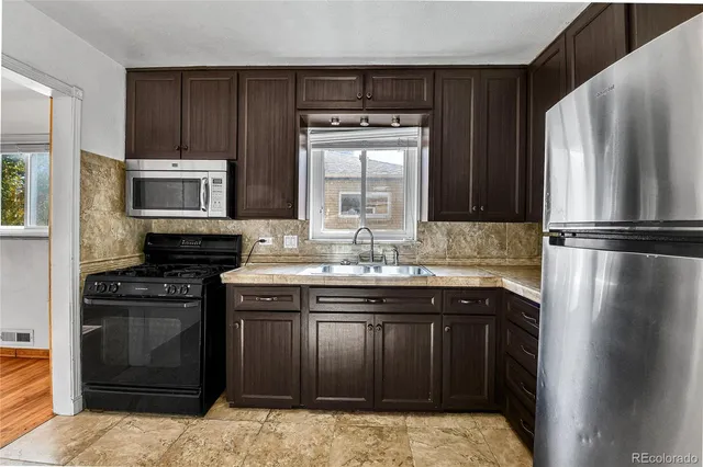 a kitchen with a sink stove and refrigerator