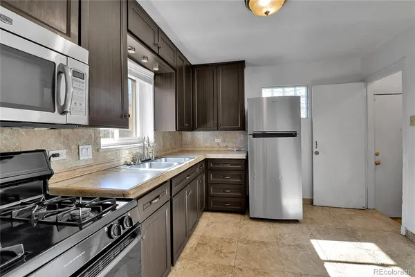 a kitchen with a stove and a refrigerator