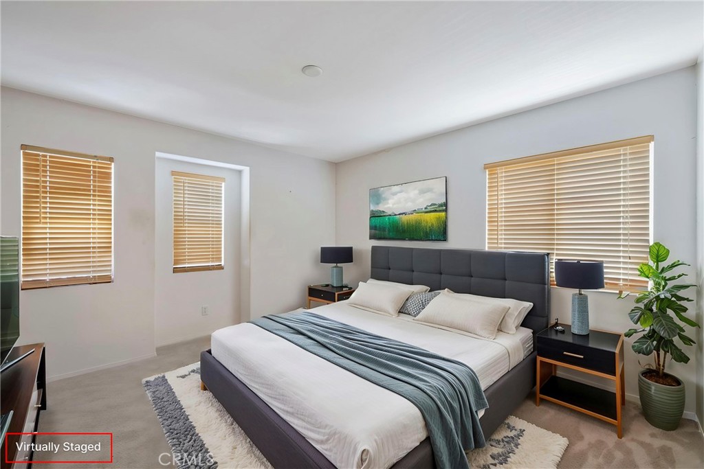 3819 St Austell Way Perris, CA 92571 - Photo 32 of 64 a bedroom with a bed and a potted plant next to a window