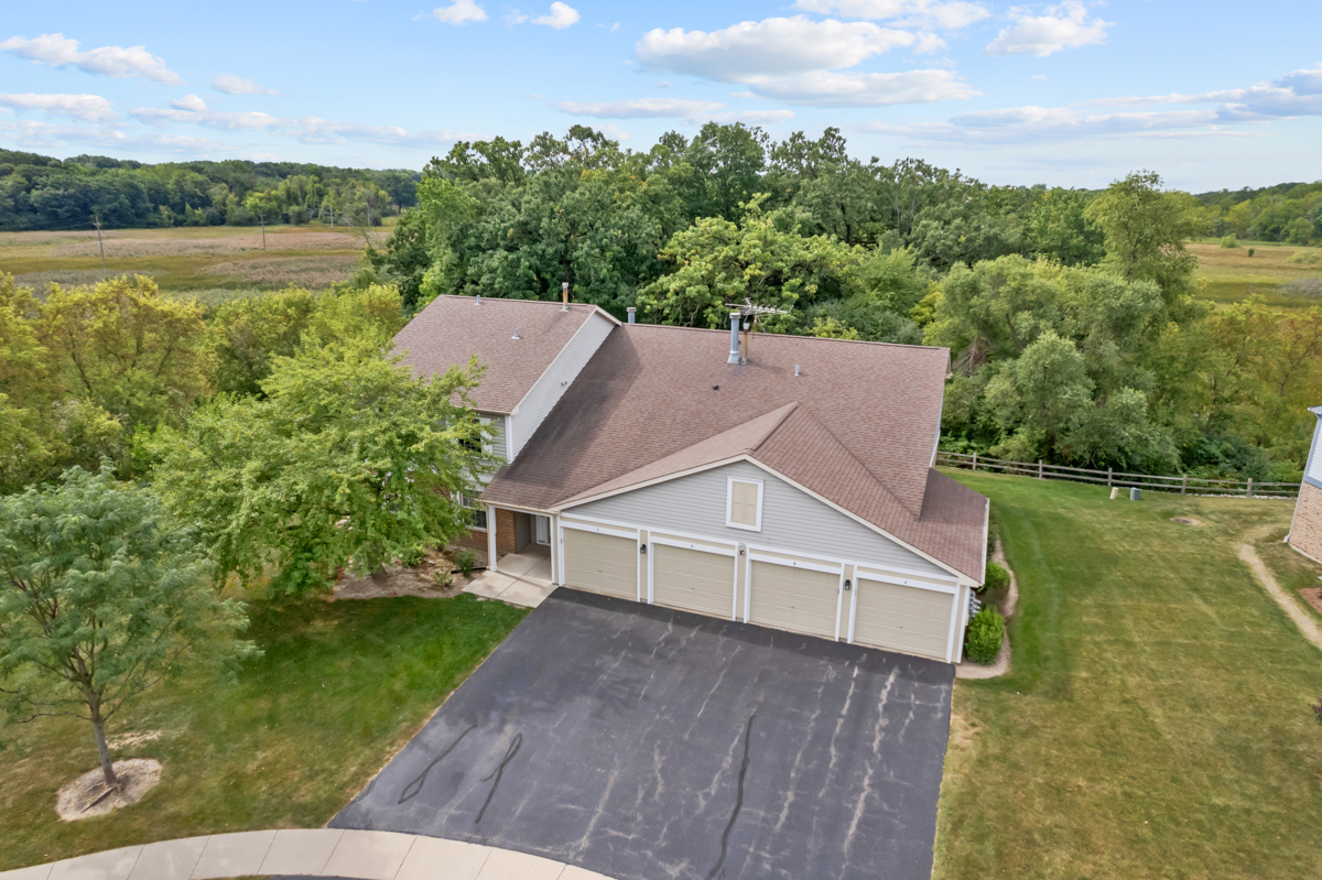 an aerial view of a house with a yard