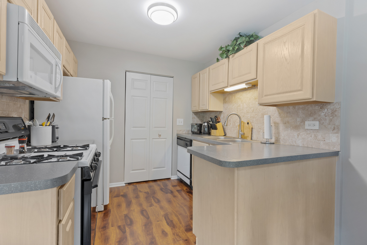 320 Crestview Drive, Unit B Wauconda, IL 60084 - Photo 16 of 28 a kitchen with stainless steel appliances granite countertop a sink stove and refrigerator
