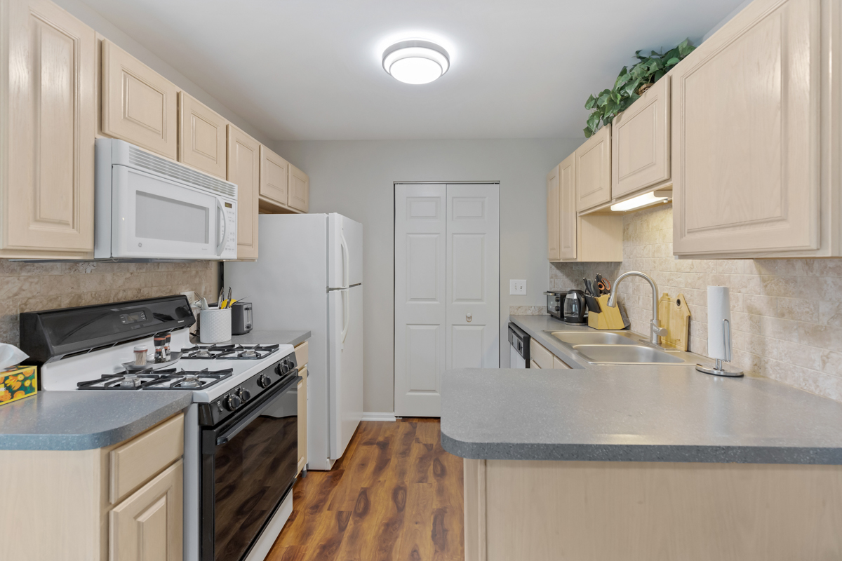 320 Crestview Drive, Unit B Wauconda, IL 60084 - Photo 17 of 28 a kitchen with stainless steel appliances granite countertop a sink stove and refrigerator