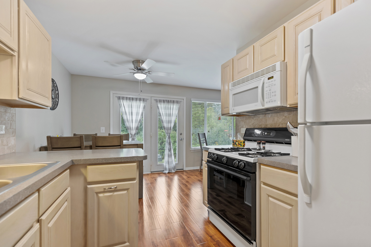 320 Crestview Drive, Unit B Wauconda, IL 60084 - Photo 18 of 28 a kitchen with a stove a sink and a refrigerator