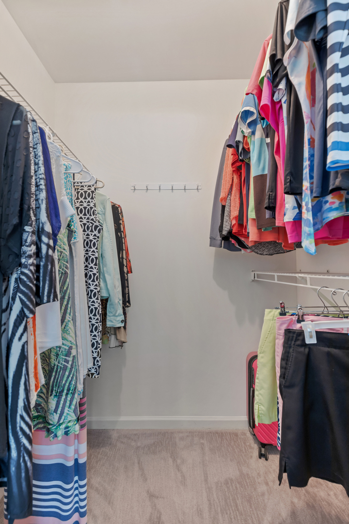 320 Crestview Drive, Unit B Wauconda, IL 60084 - Photo 21 of 28 a view of walk in closet with clothes and shoes