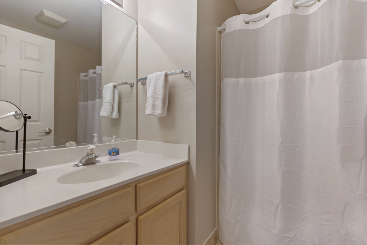 320 Crestview Drive, Unit B Wauconda, IL 60084 - Photo 23 of 28 a bathroom with a sink and a mirror