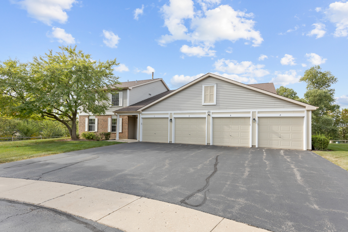 320 Crestview Drive, Unit B Wauconda, IL 60084 - Photo 10 of 28 a front view of a house with a yard and garage
