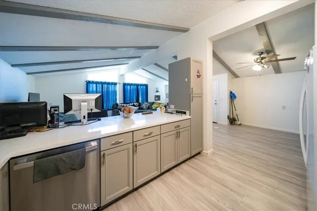 a kitchen with a sink cabinets and wooden floor