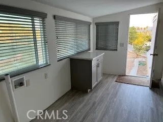 a kitchen with a wooden floor and a large window