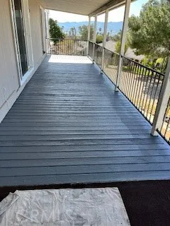 a view of a balcony with wooden floor