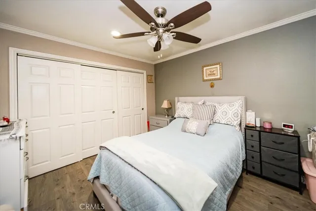 a bedroom with a bed and a ceiling fan