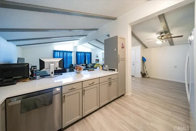 a kitchen with a sink cabinets and wooden floor