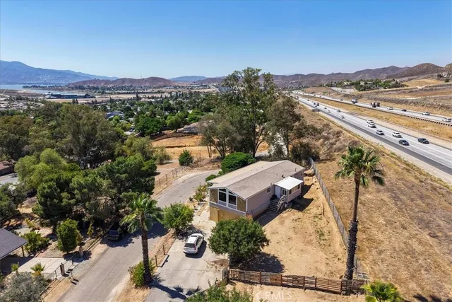 an aerial view of a house with a mountain