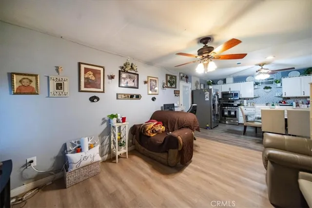 a living room with furniture and kitchen view