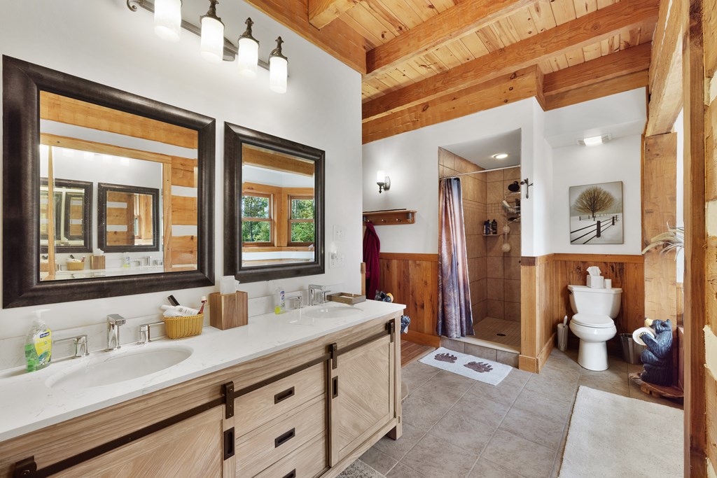 179 Cessna Loop Blue Ridge, GA 30513 - Photo 13 of 57 a bathroom with a granite countertop sink mirror and a