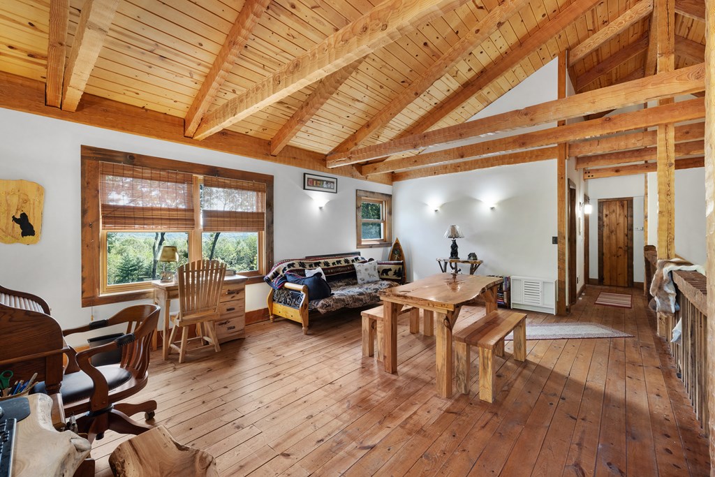 179 Cessna Loop Blue Ridge, GA 30513 - Photo 26 of 57 a living room with furniture a wooden floor and a large window