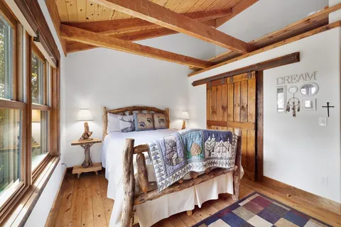 a bedroom with furniture and a window