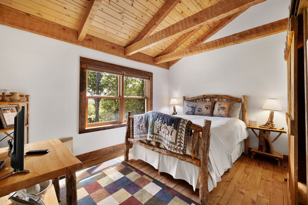 179 Cessna Loop Blue Ridge, GA 30513 - Photo 28 of 57 a bedroom with a bed next to a window