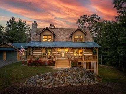 a kitchen with stainless steel appliances granite countertop a refrigerator a stove and a sink with wooden floor