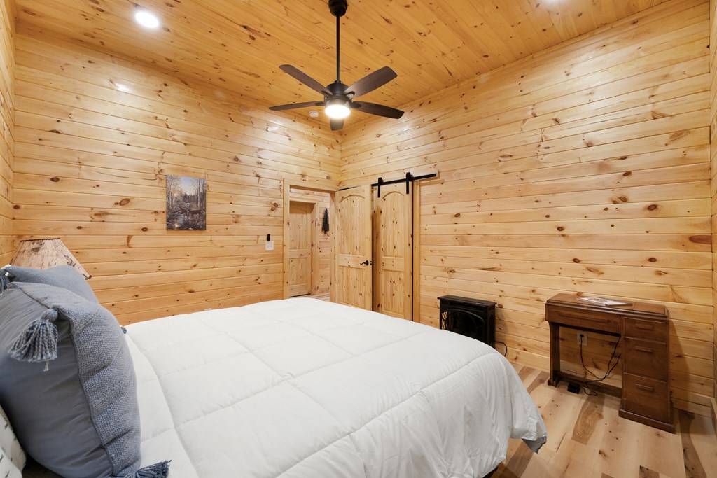 179 Cessna Loop Blue Ridge, GA 30513 - Photo 39 of 57 a spacious bedroom with a bed and a table