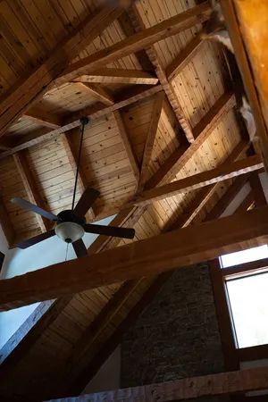 a view of two chairs in the balcony with wooden floor