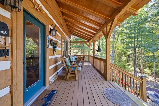 an aerial view of a house with outdoor space and trees all around