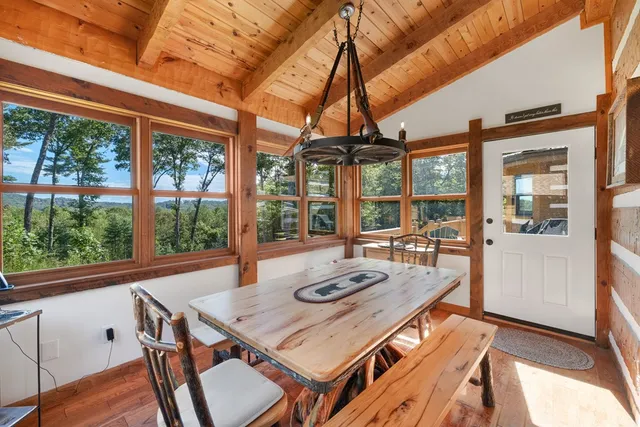 a view of a livingroom with furniture wooden floor and windows