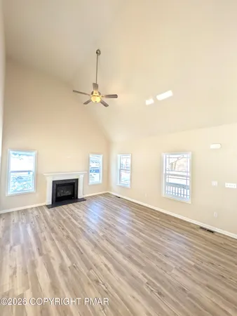 a kitchen with stainless steel appliances a stove top oven a sink a dining table and chairs