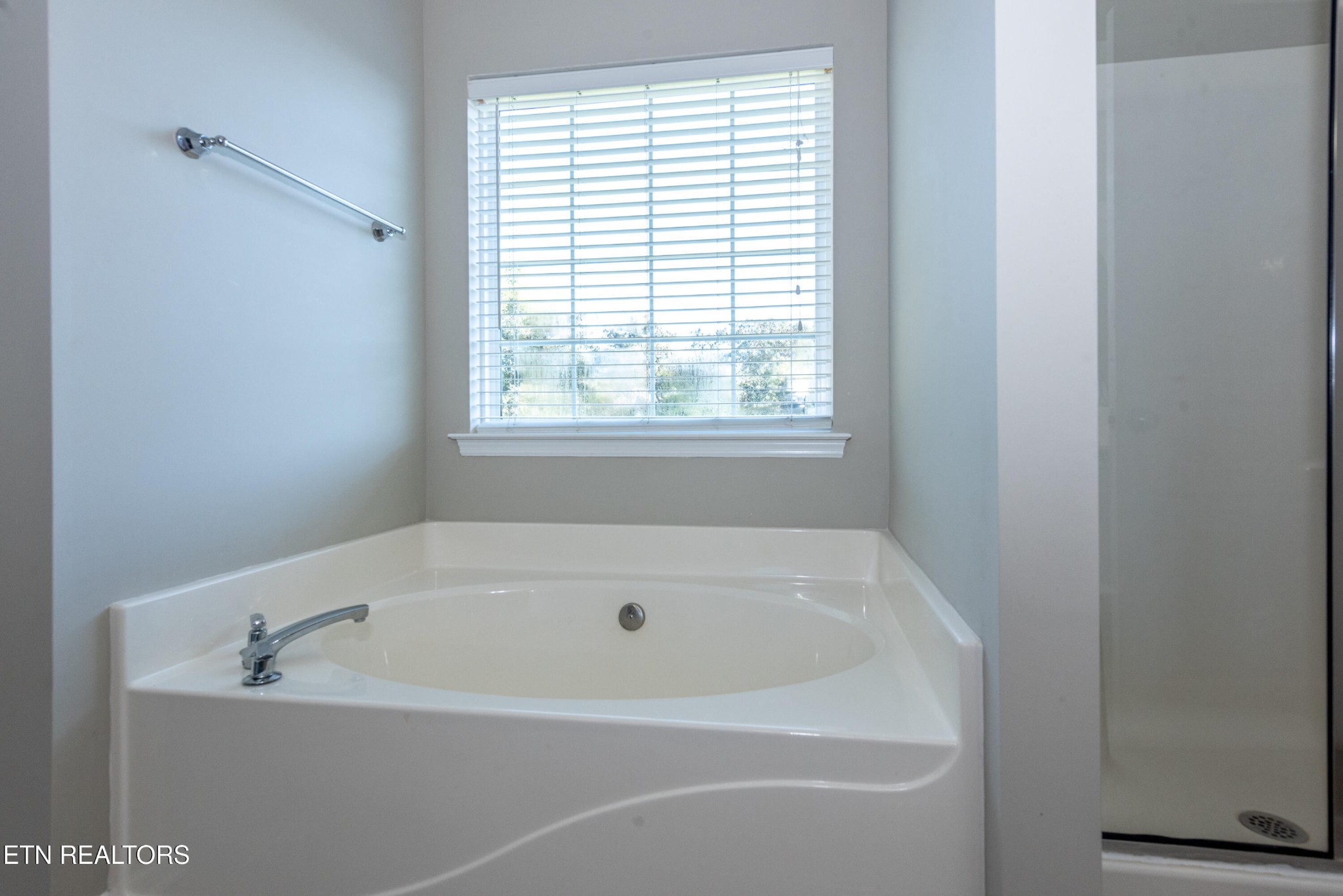 1600 Legacy Park Road Knoxville, TN 37922 - Photo 33 of 58 a white bath tub sitting in a bathroom next to a window