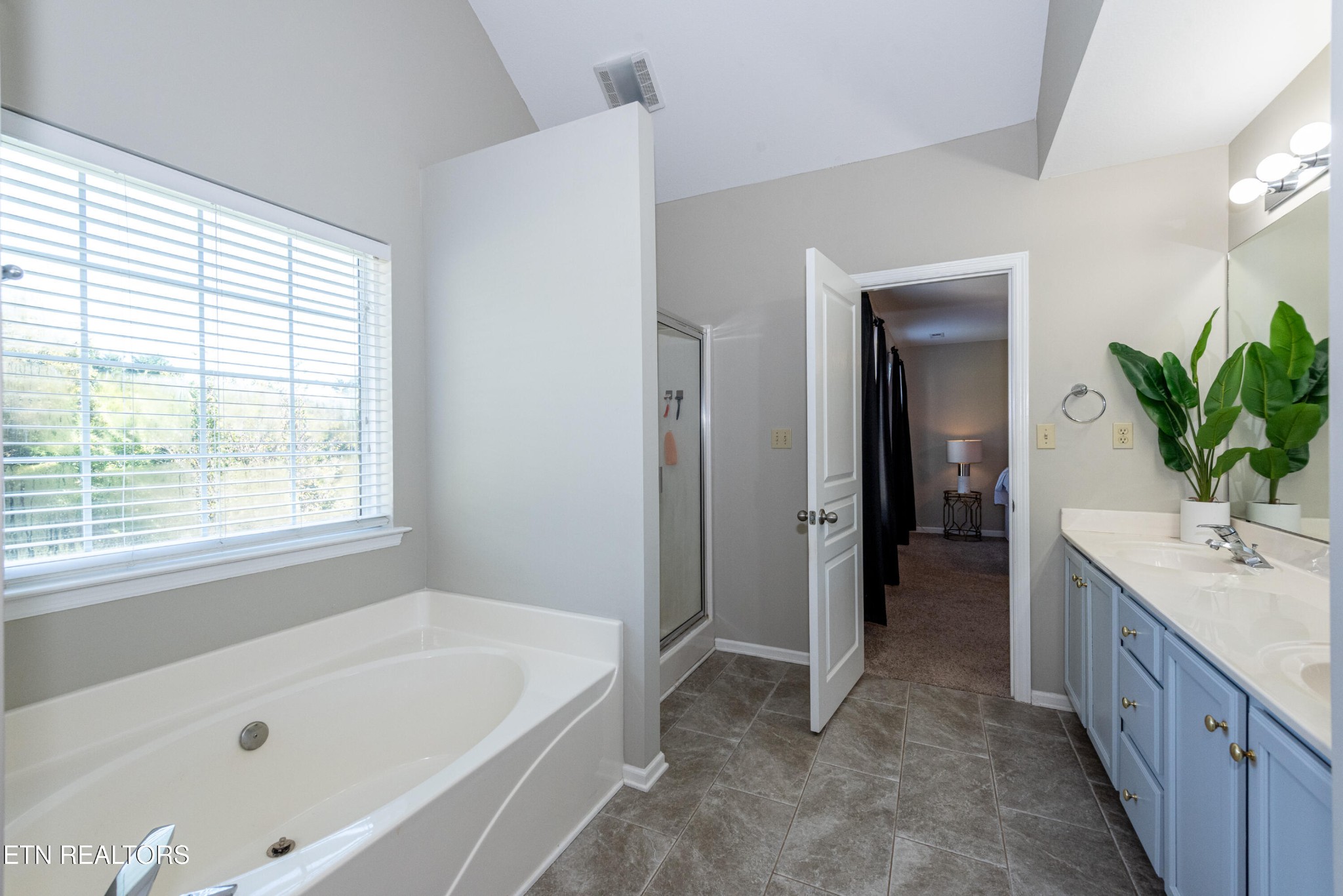 1600 Legacy Park Road Knoxville, TN 37922 - Photo 35 of 58 a bathroom with a tub a sink and a window
