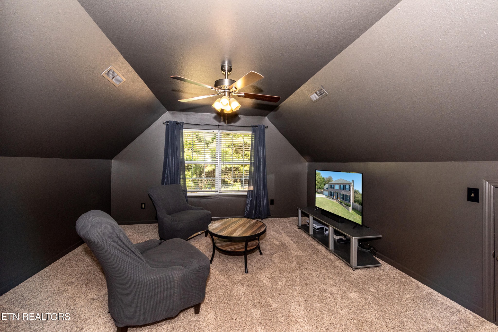 1600 Legacy Park Road Knoxville, TN 37922 - Photo 42 of 58 a living room with furniture a chandelier and a flat screen tv