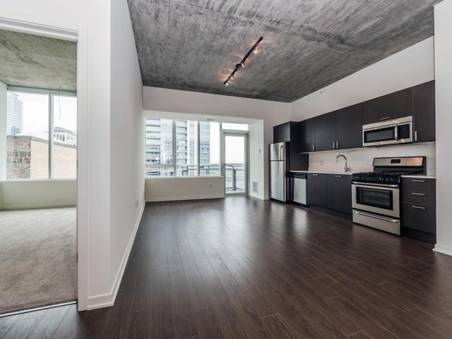 1345 South Wabash Avenue, Unit 902 Chicago, IL 60605 - Photo 7 of 10 a view of wooden floor and windows in an empty room