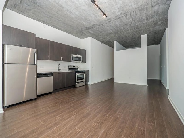 1345 South Wabash Avenue, Unit 902 Chicago, IL 60605 - Photo 9 of 10 a view of a kitchen with a sink stove refrigerator and cabinets