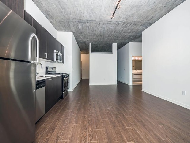 1345 South Wabash Avenue, Unit 902 Chicago, IL 60605 - Photo 10 of 10 a kitchen with stainless steel appliances granite countertop a refrigerator and a stove