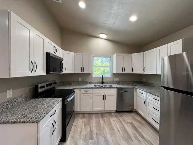 a kitchen with a sink stove and refrigerator