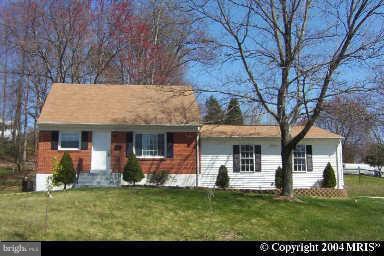 3319 Beaumont Road Woodbridge, VA 22193 - Photo 1 of 1 a front view of a house with a garden