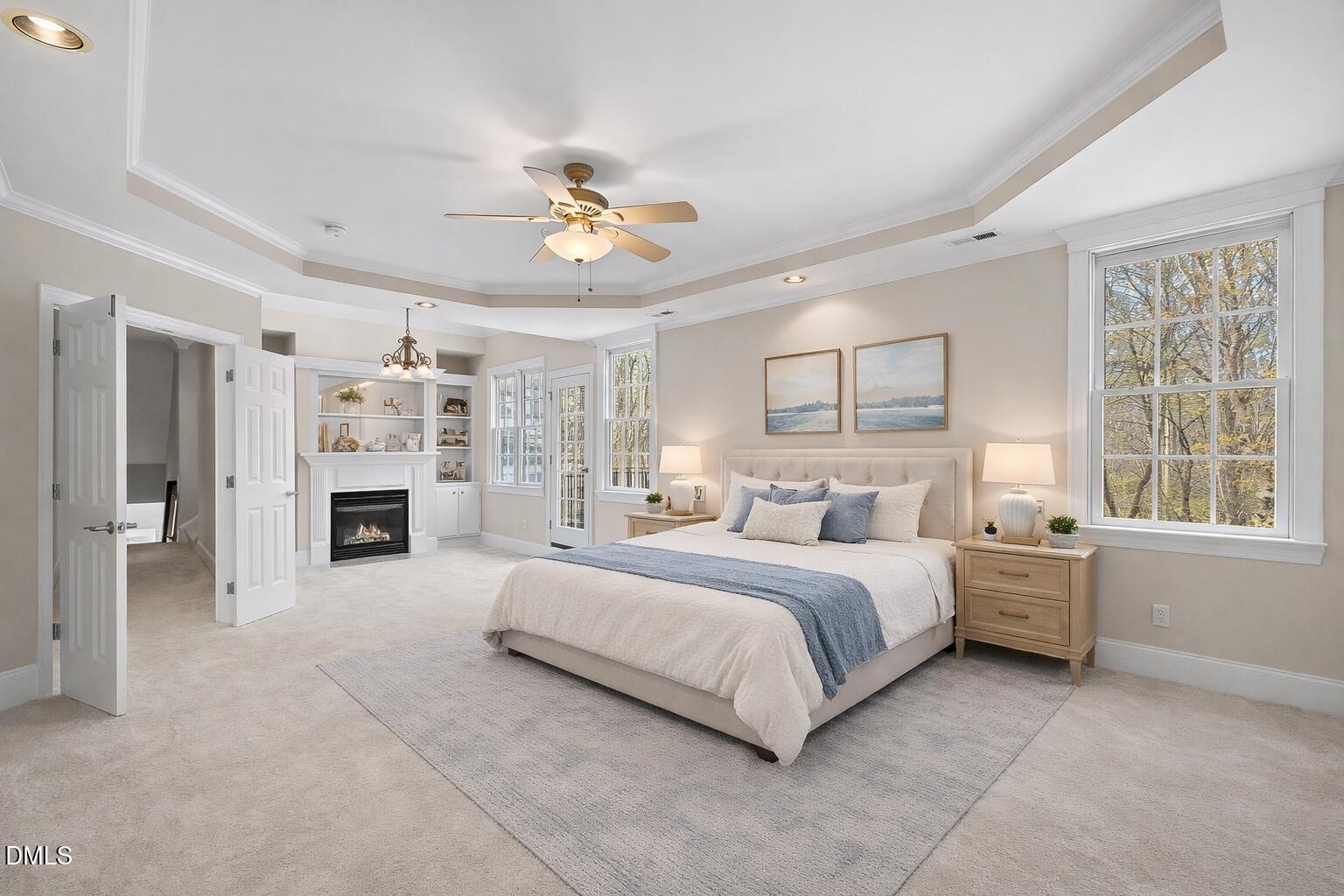 1525 Eglantyne Court Raleigh, NC 27613 - Photo 33 of 105 a spacious bedroom with a large bed and a chandelier fan