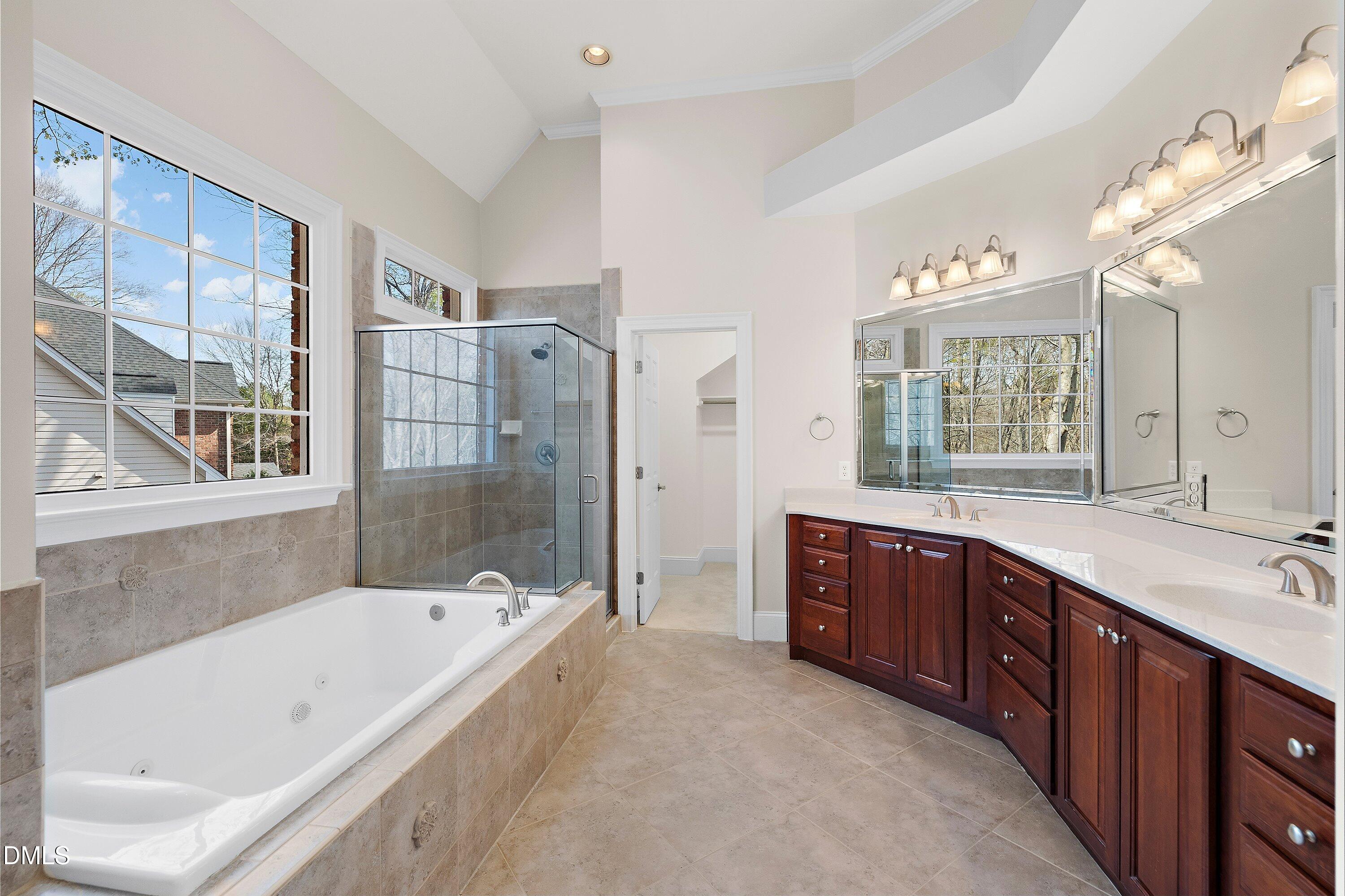 1525 Eglantyne Court Raleigh, NC 27613 - Photo 39 of 105 a spacious bathroom with a tub sink shower and mirror