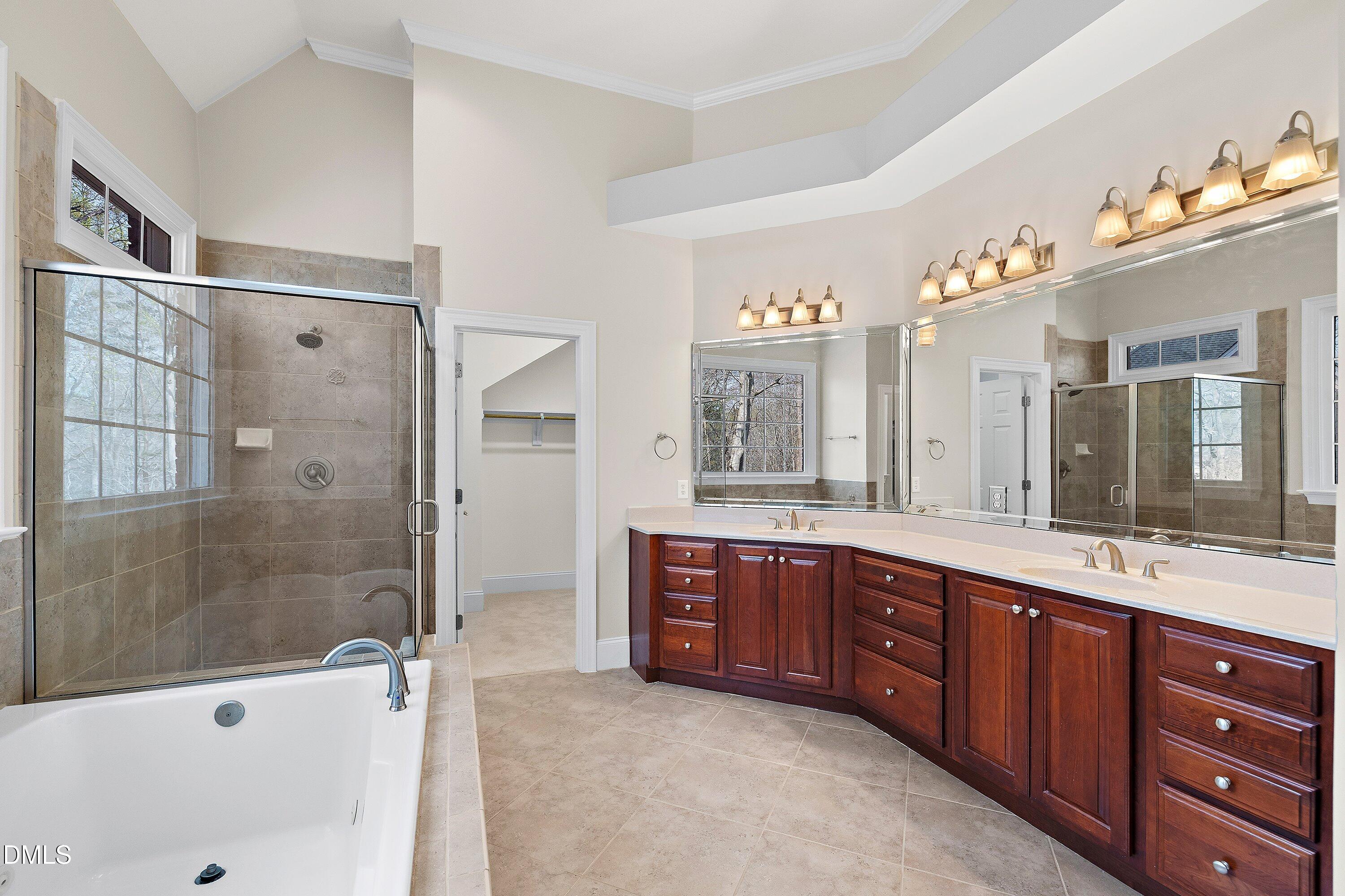1525 Eglantyne Court Raleigh, NC 27613 - Photo 40 of 105 a spacious bathroom with a tub sink shower and mirror