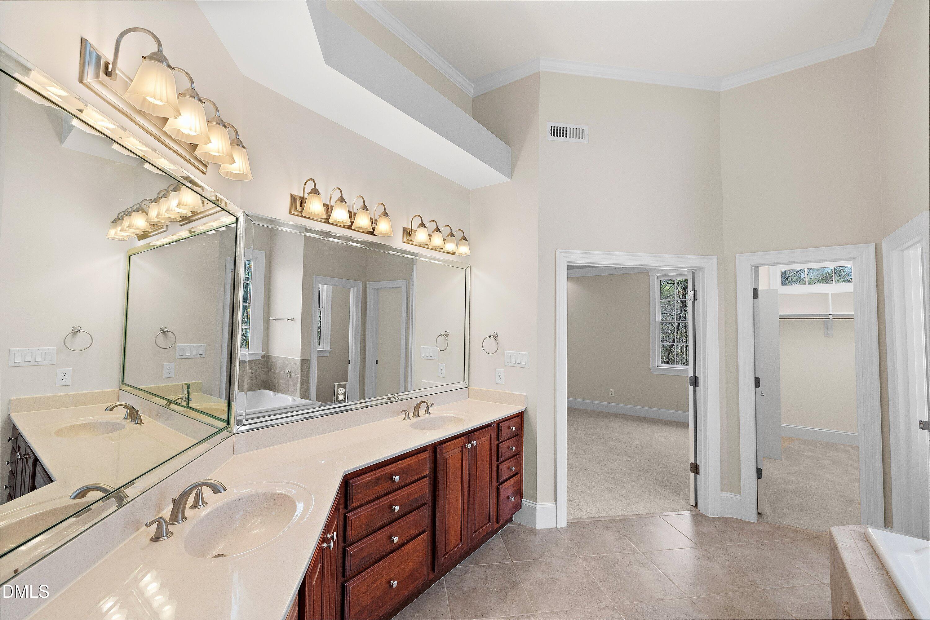 1525 Eglantyne Court Raleigh, NC 27613 - Photo 43 of 105 a spacious bathroom with a double vanity sink mirror and shower