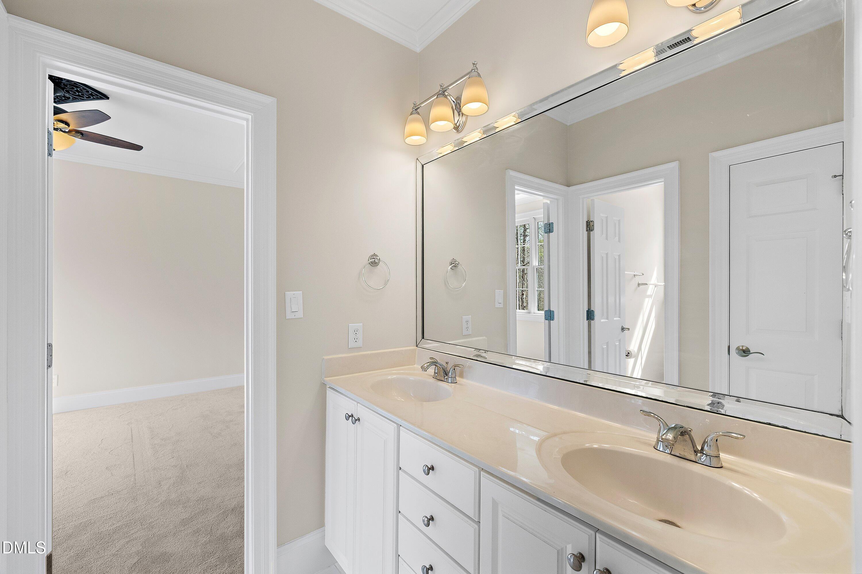 1525 Eglantyne Court Raleigh, NC 27613 - Photo 57 of 105 a bathroom with a double vanity sink and a mirror